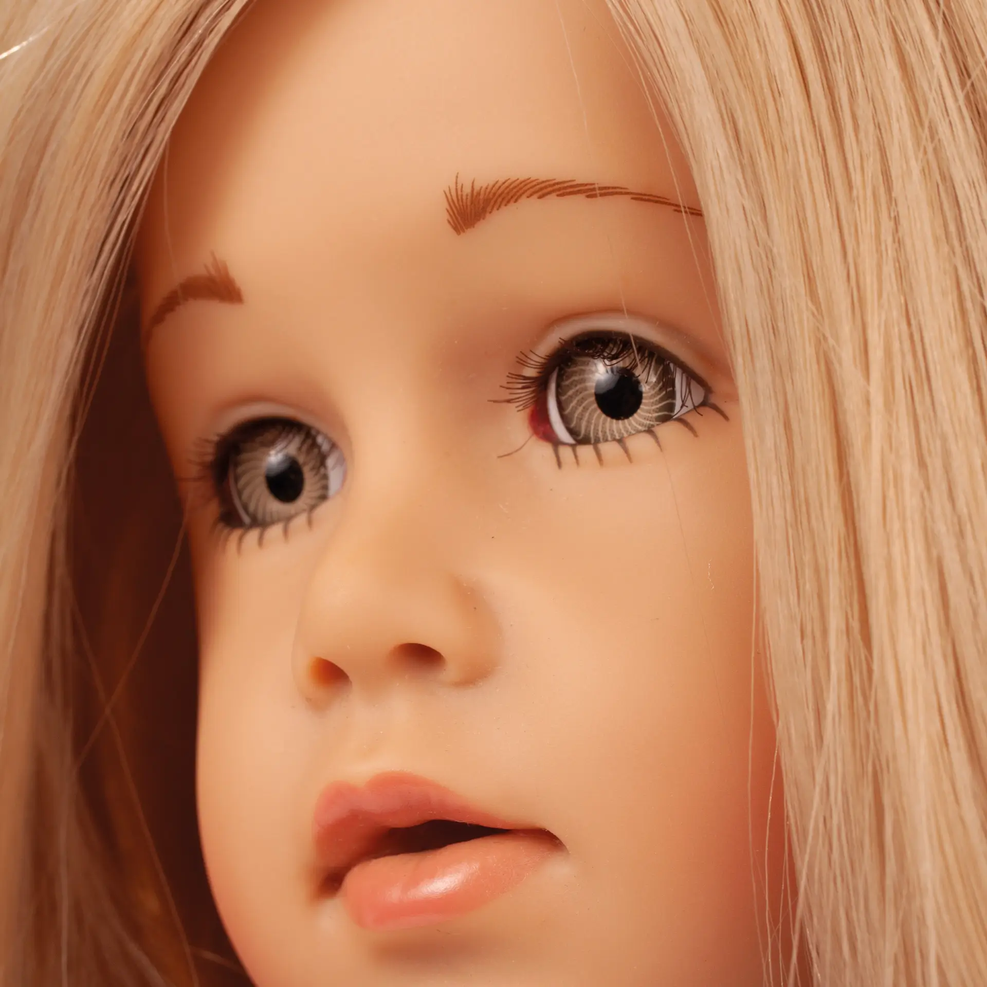 Stehpuppe 45-50 cm mit blondem Haar und steingrauen Augen. Portraitaufnahme von Goetz