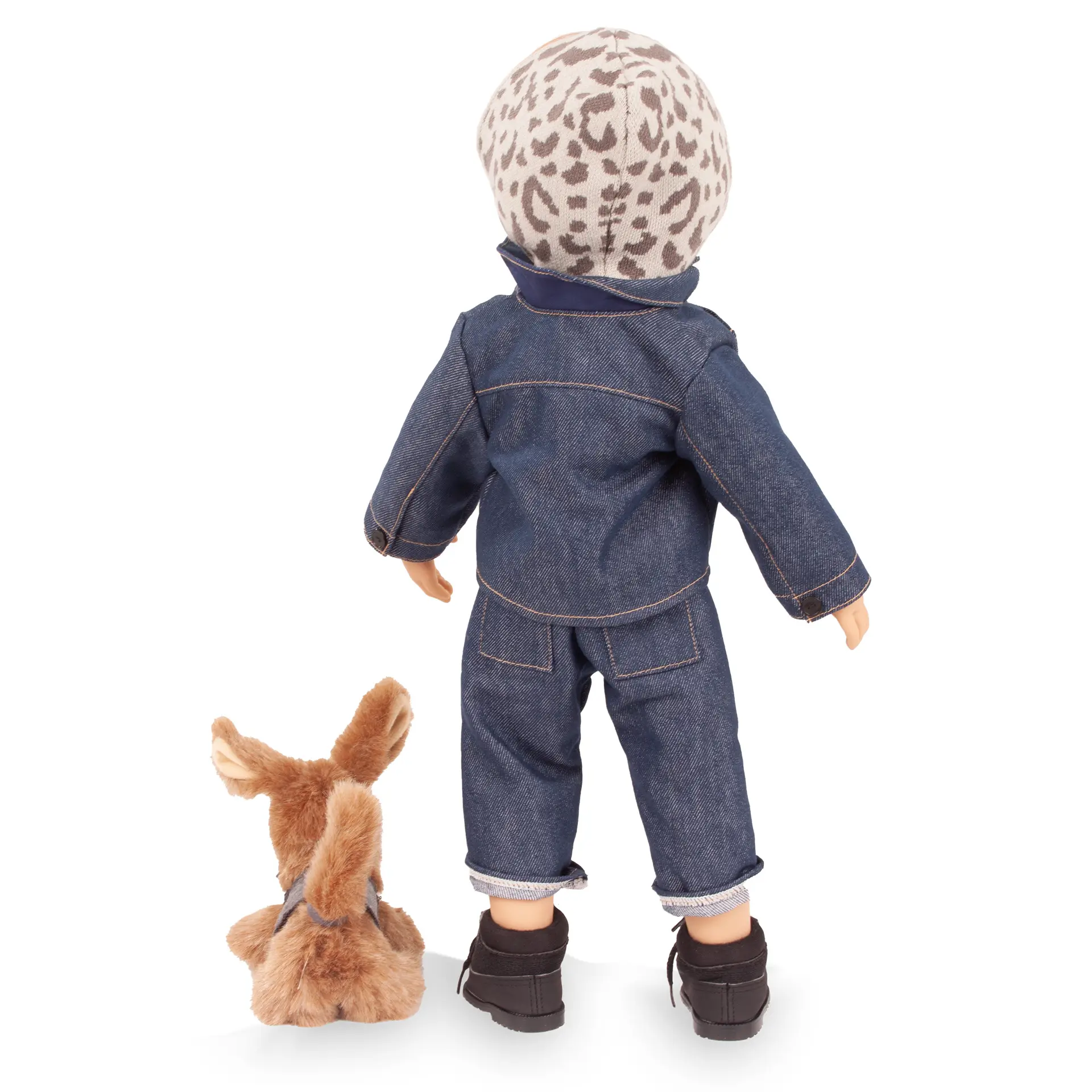 Rueckansicht von Stehpuppe Gr. 50 cm, sie traegt einen Strick-Hoodie in Leo-Design mit Jeanshose, Jeansjacke und schwarzen Booties. Dazu ein braunfarbiger Hund mit einem Cape von Goetz