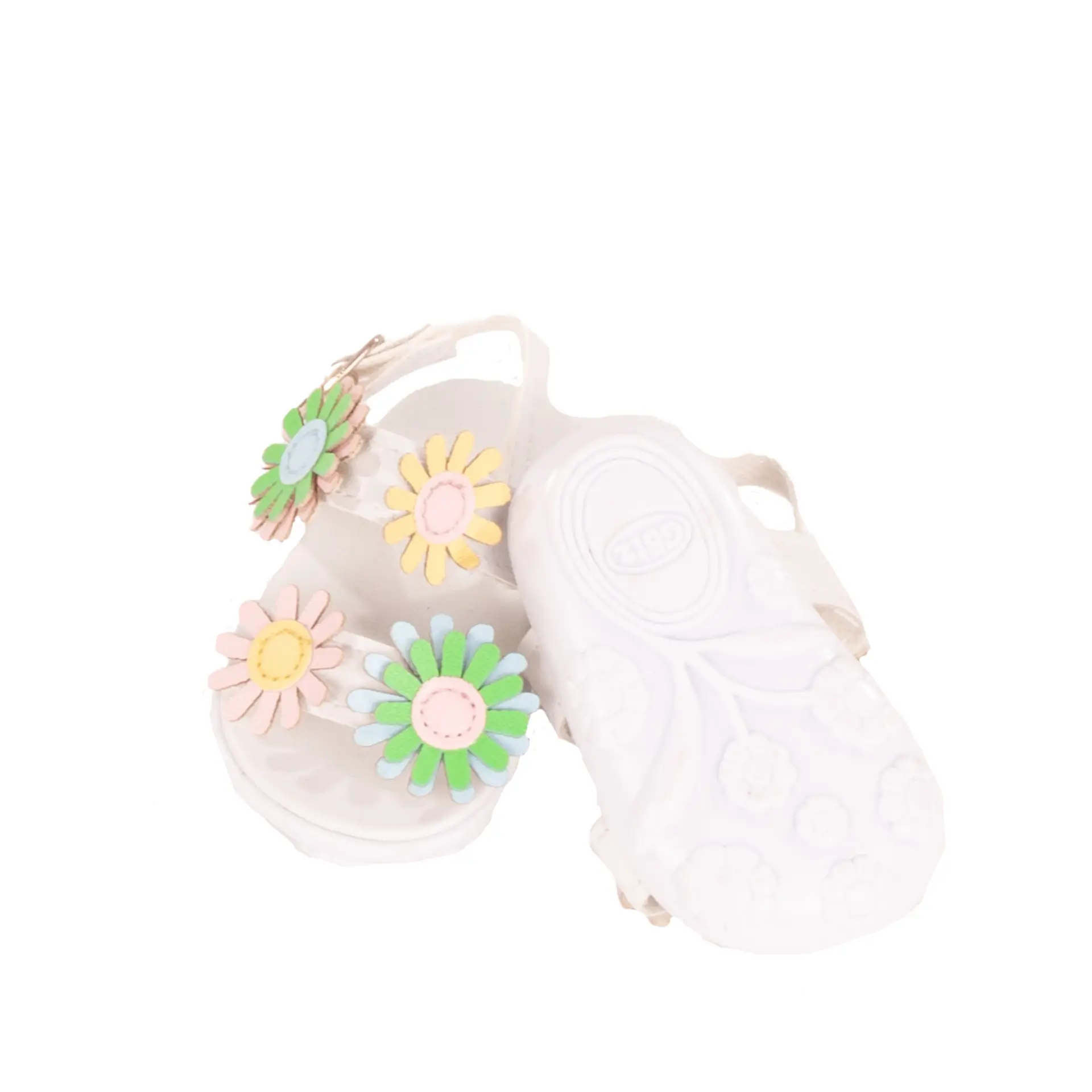 Sandalen mit Blumen in geld-gruen fuer Babypuppen Gr. 42-46 cm und Stehpuppen Gr. 45-50 cm mit Ansicht der Sohlen mit Blumenmuster. Von Goetz