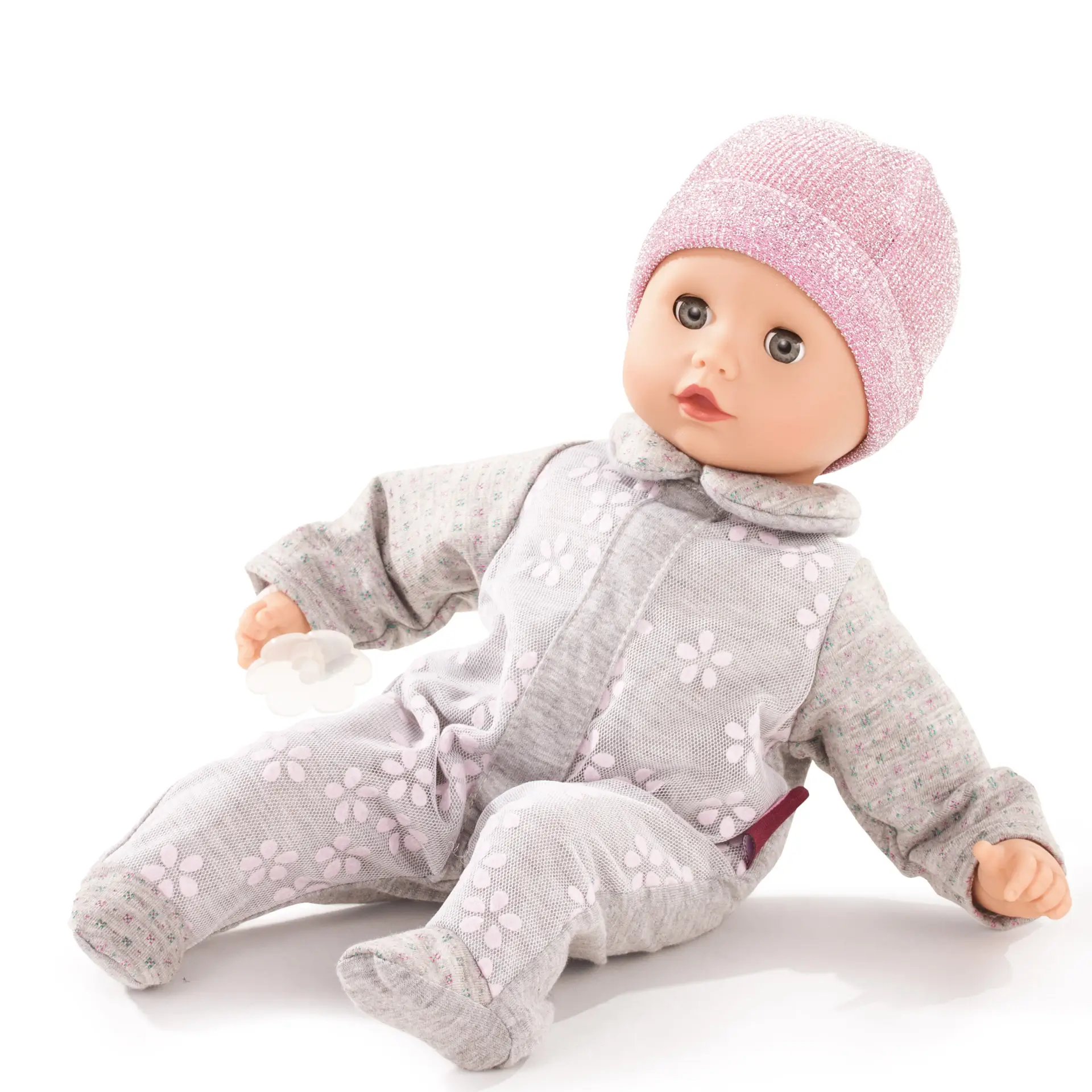 Babypuppe Gr. 30 cm mit blauen Schlafaugen, ohne Haare in einem grau-rosafarbenen Strampler mit Blumenapplikationen und einer rosa Glitzermuetze, dazu ein Schnuller. Von Goetz