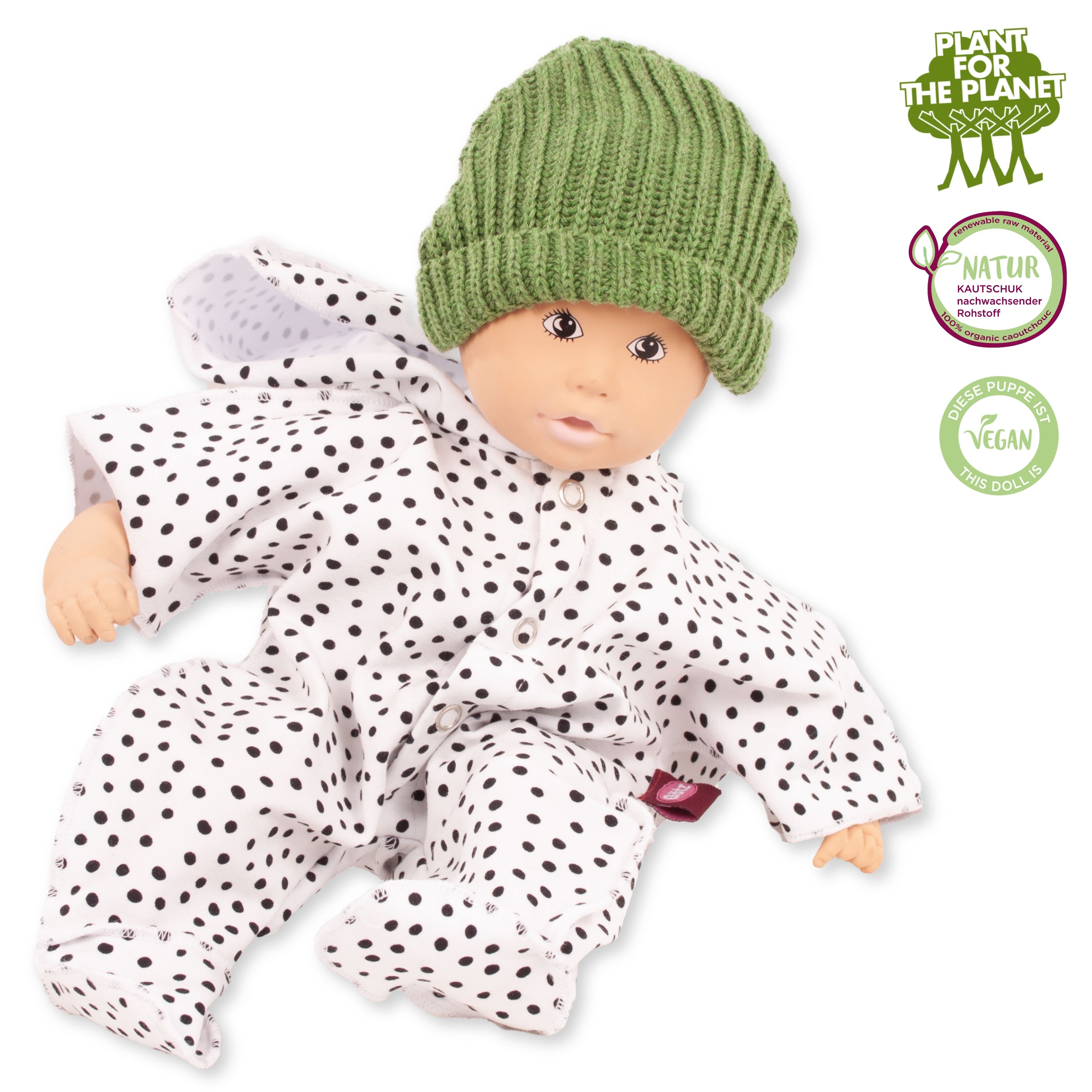 Badepuppe aus Naturkautschuk und vegan  mit gemalten Augen in einem weiss-schwarz getupftem Anzug und gruener Strickmuetze von Goetz