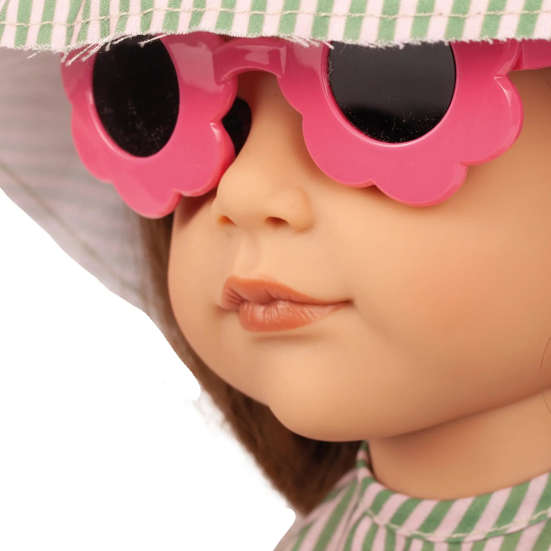 Portrait von Stehpuppe Gr. 50 cm mit braunem Haar und braunen Augen. Sie trägt einen gruen-gestreiften Hut und Sonnenbrille von Goetz