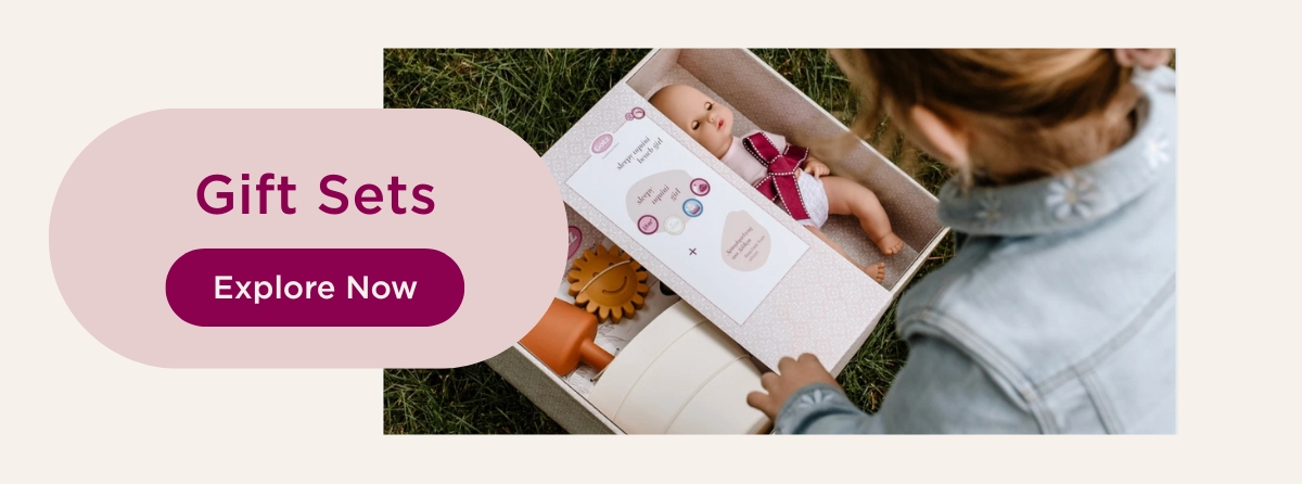 Child opening a gift box with a doll and doll accessories, lovingly arranged as a gift idea