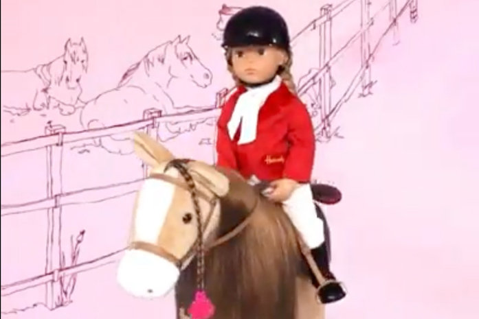 Reiterstehpuppe sitzt auf einem Plueschpferd mit langer Maehne auf einer Weide